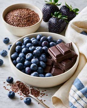 Elegant flat lay of blueberries flaxseed and dark chocolate highlighting perimenopause cognitive wellness and brain nutrition