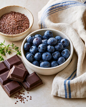 Elegant flat lay of blueberries flaxseed and dark chocolate highlighting perimenopause cognitive wellness and brain nutrition