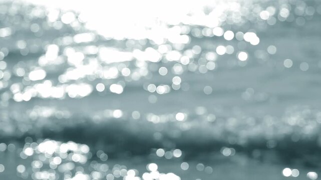 Sea. Sea waves. Abstract view of blue sea with white ripples on water and white sun glare on sunny summer day. Nature backdrop. Natural background. Blurred bokeh background.