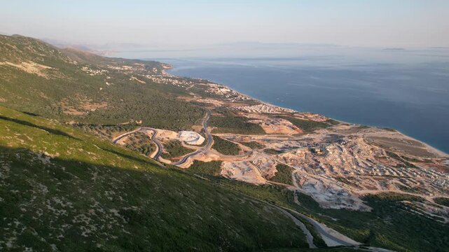 Aerial view of the winding Llogara Pass mountain road near Vlora and Zeus mountain, amazing scenery view. Aerial panoramic drone view from above, top view from drone. 
