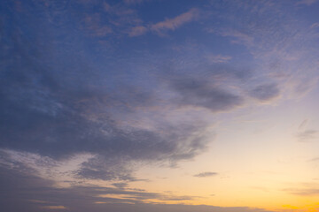 Fototapeta premium Golden Sunrise Sky with Dramatic Clouds and Sunlight,Breathtaking scenic view of a vibrant golden sunrise breaking through a layer of textured altocumulus clouds in the early morning sky, creating.