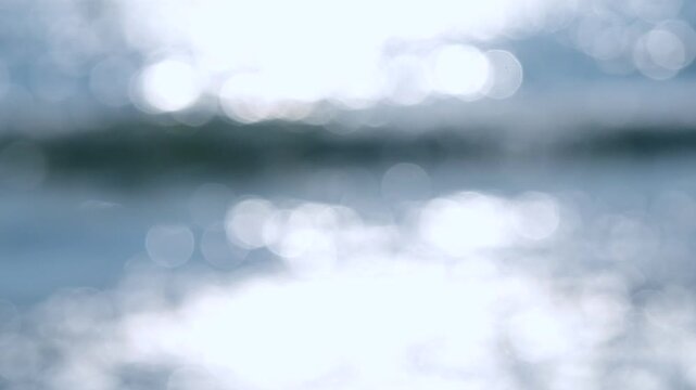 Sea. Sea waves. Abstract view of blue sea with white ripples on water and white sun glare on sunny summer day. Nature backdrop. Natural background. Blurred bokeh background.