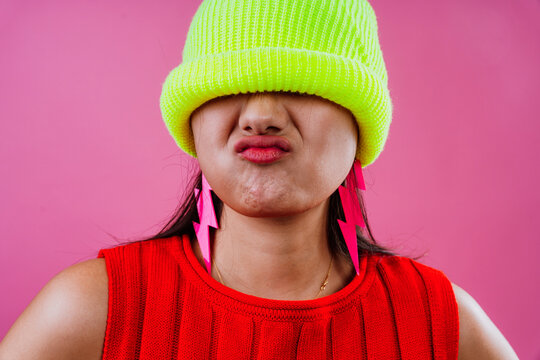Young woman showing playful expression with her mouth