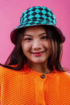 Young woman smiling wearing checkered bucket hat portrait