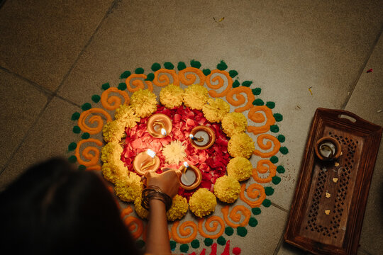 People Gather Around a Circle of Flowers and Candles During a Festival