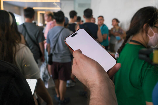 Tourist Holding Phone in Crowd