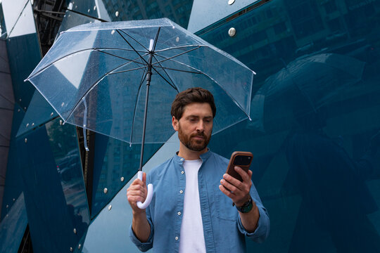 A successful-looking man with a phone in his hand.