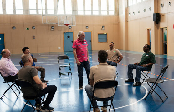 Diverse men participating in a community support discussion group
