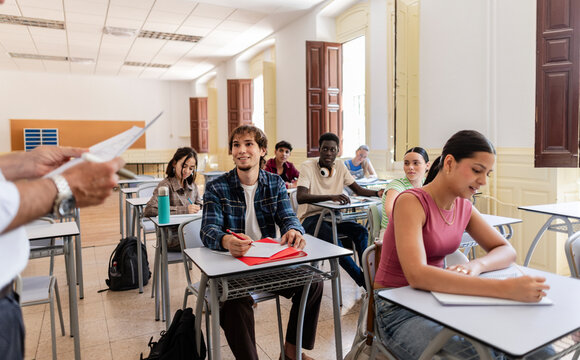 Diverse students engaging with teacher in university classroom