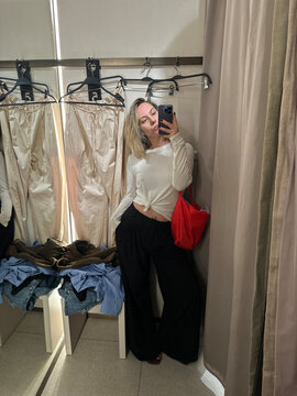 Fashion Influencer Filming Fitting Room Outfit Review with Smartphone