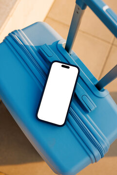 Travel smartphone mockup with white screen on suitcase