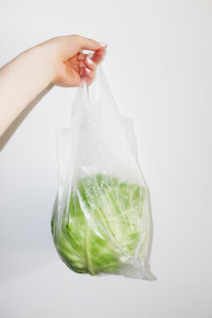 Green fresh cabbage salad vegetable in a clear plastic bag with flash