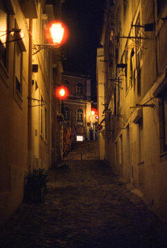 Lamplit Lisbon Alley at Night