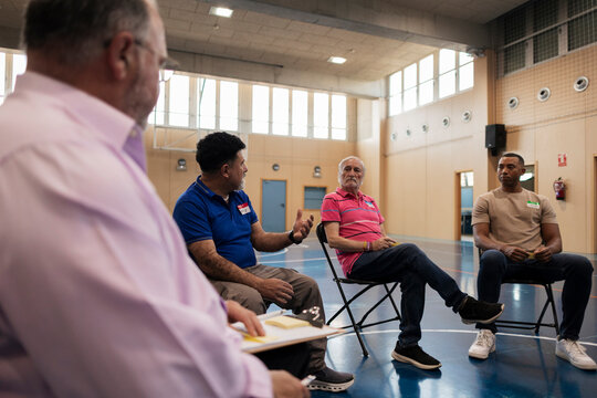 Diverse men participating in a support group meeting