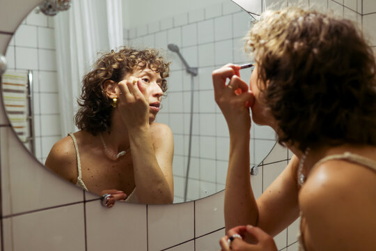 woman doing makeup at home