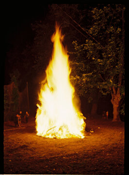 Big bonfire burning bright at night during outdoor gathering