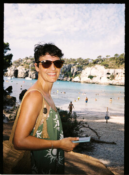 Person smiling and relaxing on a beautiful sandy beach