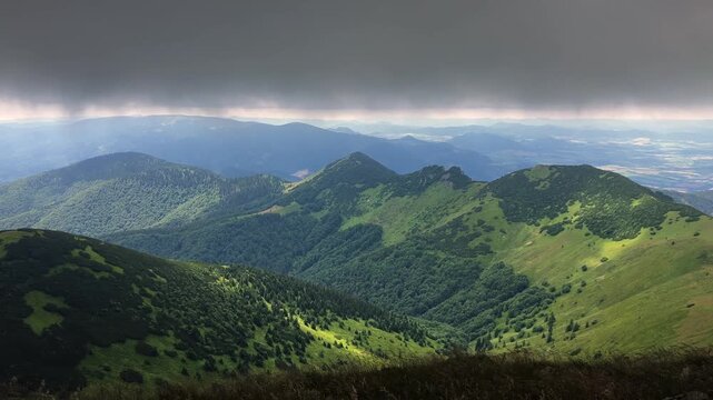 Suchy and Bile skaly, view from Maly Krivan, Mala Fatra, Slovakia. Mountain landscape in summer, with moving clouds under overcast skies.