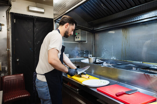 Chef slicing Beyti kebab in the kitchen