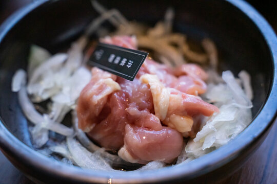 A hotpot meat platter presents thinly sliced beef, pork, and chicken arranged neatly on a serving plate. Close-up compositions emphasize beef marbling, pork color, and the natural fiber patterns of ch