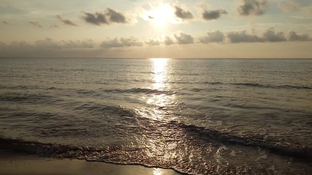 Golden sunset at Kotogahama Beach with sunbeams breaking through clouds, Shimane, Japan
