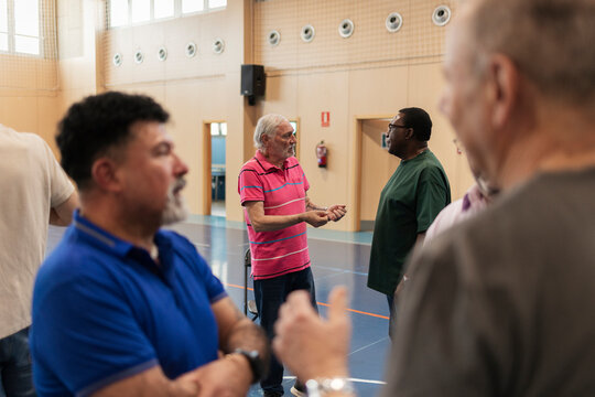 Senior men engaging in discussion at community center