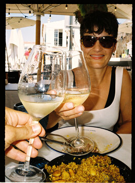 Couples toasting white wine during summer vacation dinner