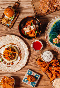 Wooden table filled with an assortment of gourmet Spanish tapas