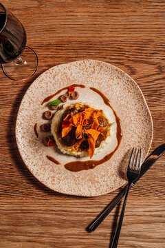 Overhead view of slow-cooked braised meat with crispy potato chips
