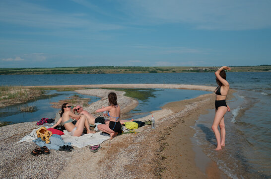 Friends relaxing by the water on a sunny summer day