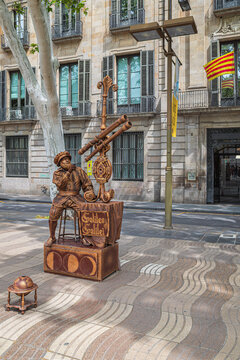 Barcelona, ​​Spain - April 15, 2024: A living statue (street artist) in period costume with a decorative telescope, depicting astronomer Galileo Galilei, on the pedestrian boulevard La Rambla.