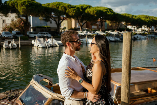 A couple embracing next to their speedboat