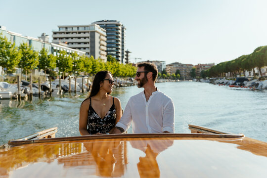 A happy Couple on a scenic boat tour at sunset