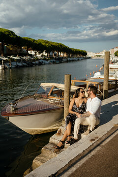Intimate Moment of Couple Chatting on Pier Near Boat