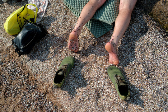 Legs of a man relaxing on a picnic blanket