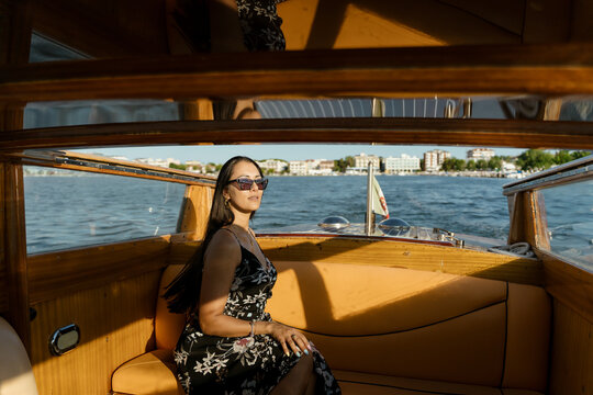A woman on a scenic speedboat tour at sunset