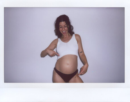 UGC Polaroid of Pregnant woman pointing belly