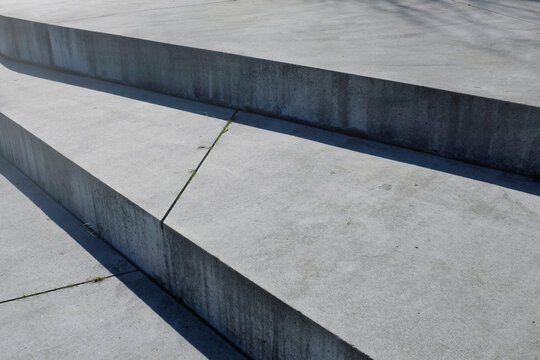 Close-up of grey concrete stairs. Urban, minimal and geometric view