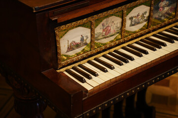 Antique Wooden Piano Keyboard with Ornate Painted Panels © ThaiKhanh