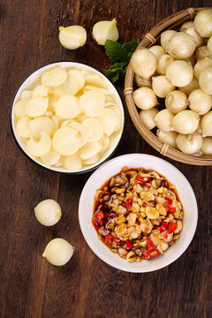 Fresh Rakkyo Garlic Bulbs with Sichuan Spicy Dish and Sliced Preparation on Wooden Table
