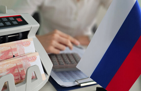 Banking process with money counter and Russian flag