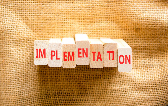 Implementation word symbol. Concept word Implementation on beautiful wooden blocks. Beautiful canvas background. Business implementation word concept. Copy space.