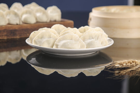 Traditional Handmade Dumplings on Plate with Bamboo Steamer - Authentic Asian Cuisine
