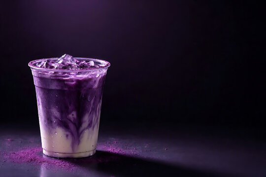 Luxurious iced ube milk latte with deep purple swirls and creamy texture in a clear plastic cup against a dark moody background