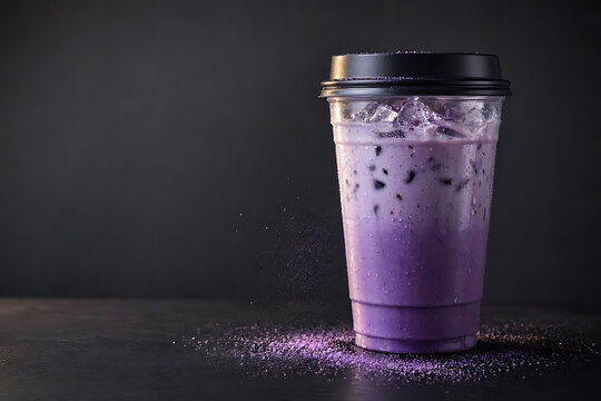 Refreshing Iced Purple Taro Milk Tea in Transparent Plastic Cup with Black Lid on Dark Background with Powder Spillage