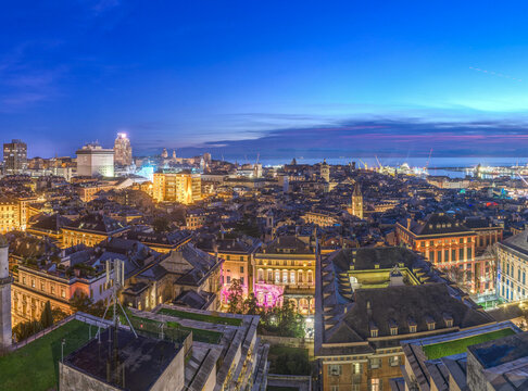 Genoa, Liguria, Italy downtown city skyline towards the Mediterranean from above at blue hour 142