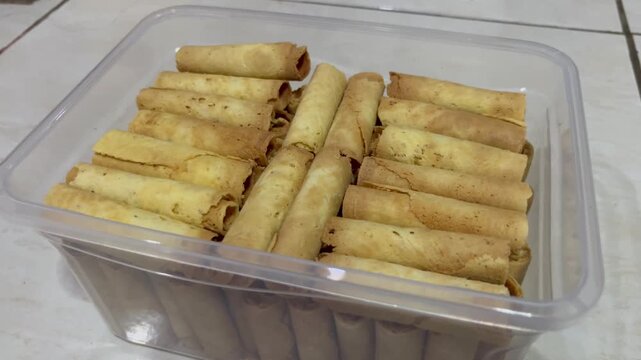 Crispy Egg Roll Biscuits Packed in Clear Plastic Container