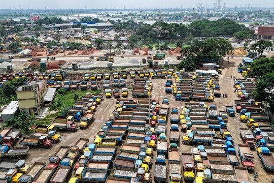 Aerial view of the Gabtoli truck terminal with rows of parked commercial vehicles on a dirt lot in Dhaka, Dhaka Division, Bangladesh.