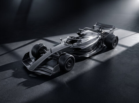 matte black formula racing car parked in studio setting with dramatic overhead spotlight illumination
