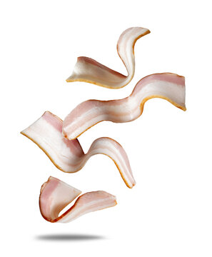 Sliced ​​bacon rashers in the air close-up isolated on a white background